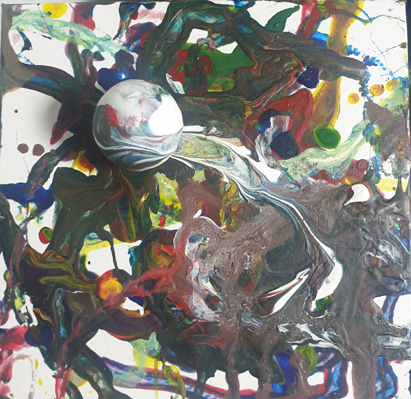 Resulting painting with a paint-covered ball and overlapping trails of red, blue, yellow, white, and dark paint